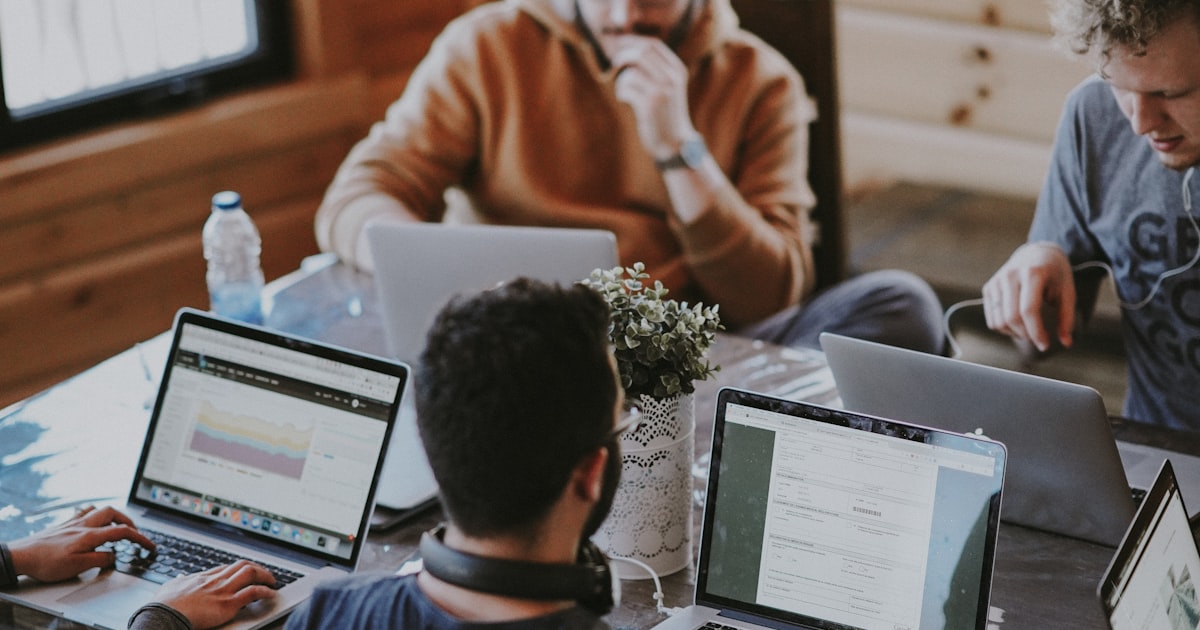 Business owner and financial advisor reviewing coverage options together at a modern office desk