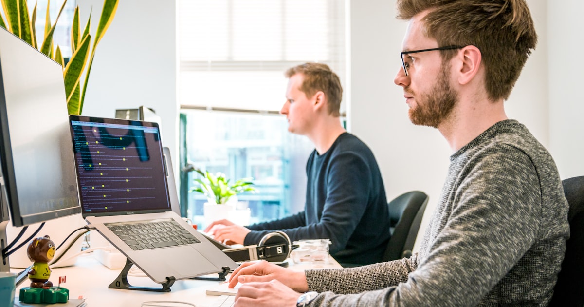 Canadian business owner reviewing risk strategy with an advisor at a modern office desk