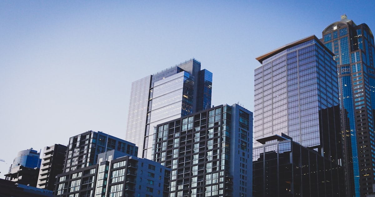 Affluent business owner outside their home or property, representing the personal asset at stake