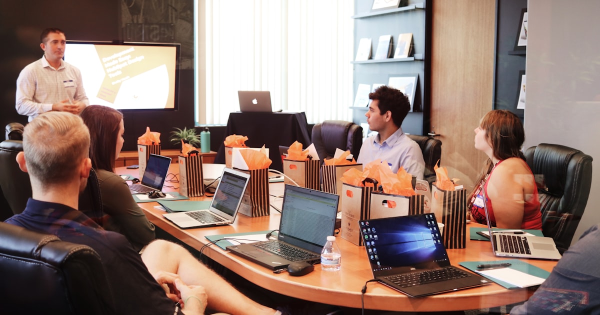 US business owner and commercial banker in mid-conversation at a modern office desk